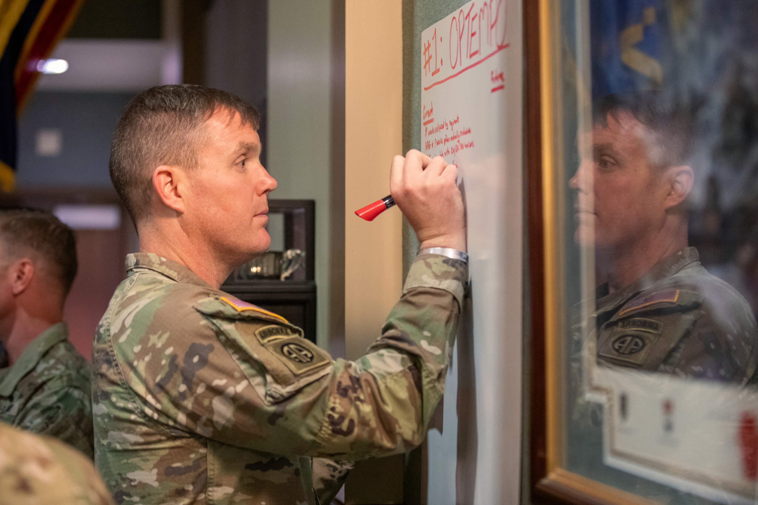 military member writing on whiteboard